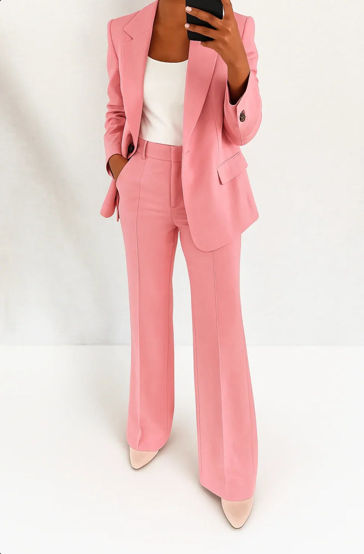 Full-length view of women's suit set styled with white pointed-toe heels and minimal accessories