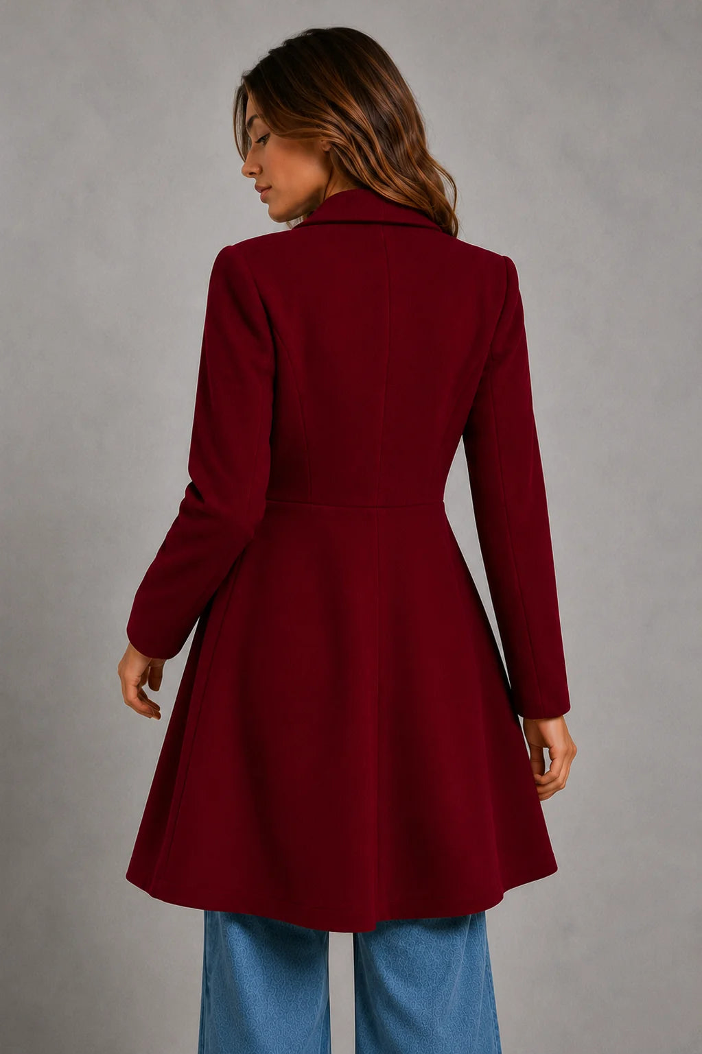 Side view of women's longline coat showing A-line silhouette and knee-length cut
