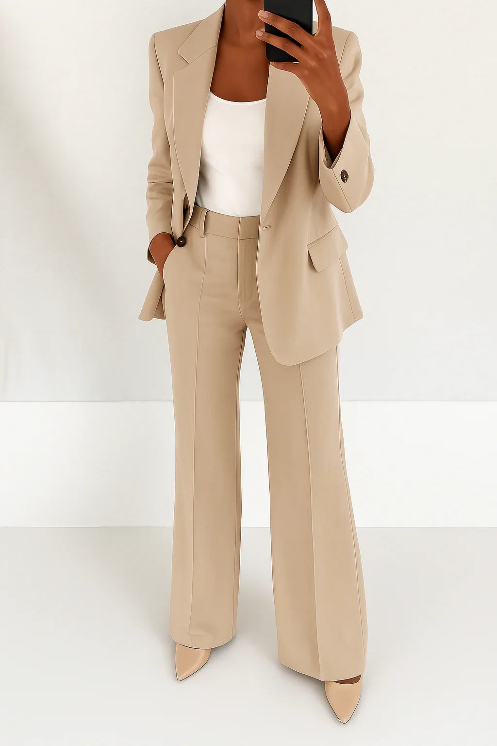 Woman styling black suit set with white top and pointed toe heels