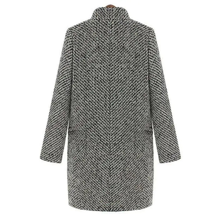 Detail of the V-neckline and single-button closure on the textured longline coat