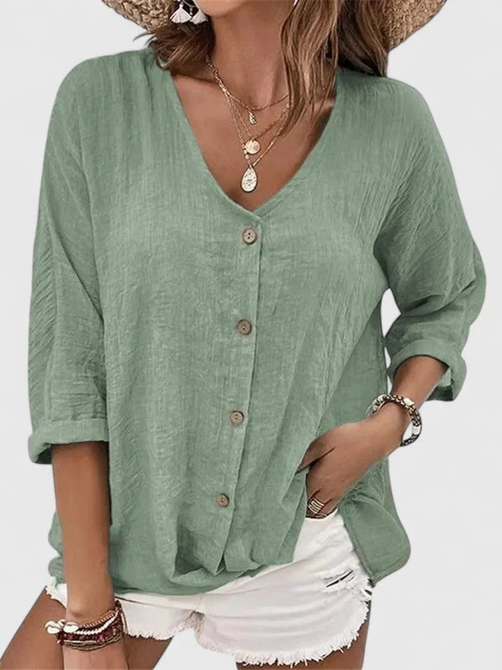 Full view of women's three-quarter sleeve blouse in blue showing relaxed silhouette and casual styling
