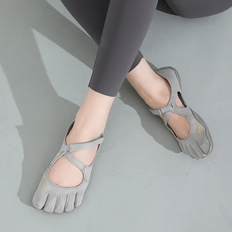 Top view of grey five toe barefoot shoes displaying elastic cross strap design