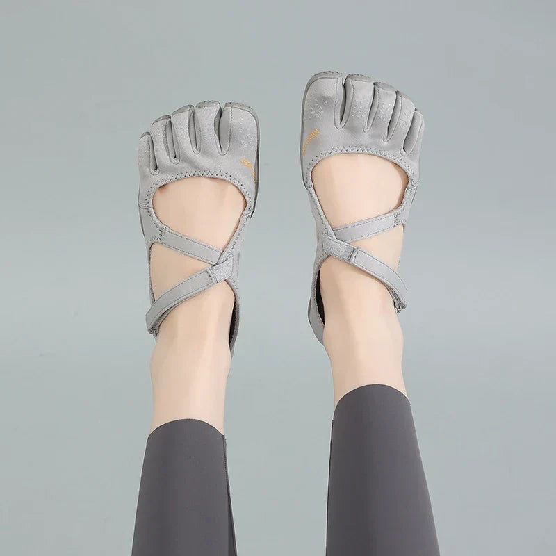 Pair of grey barefoot five toe shoes showcasing natural movement footwear design
