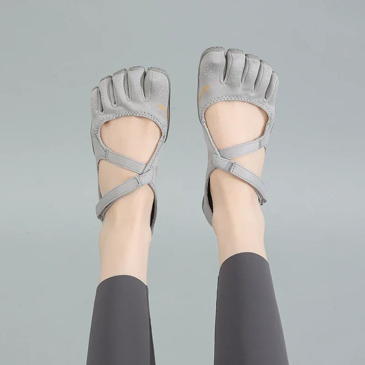 Pair of grey barefoot five toe shoes showcasing natural movement footwear design