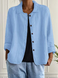 Women's button-front shirt in light blue with open collar and three-quarter sleeves, worn with black vest