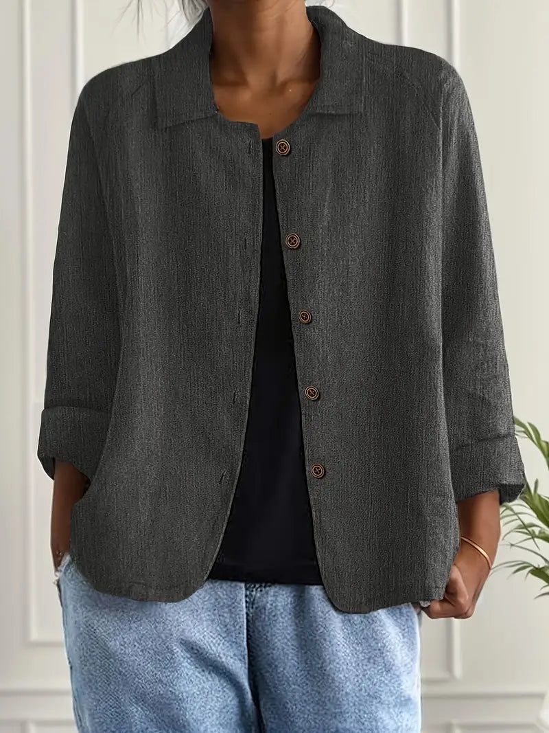 Casual styling of women's button-front shirt paired with denim trousers and trainers