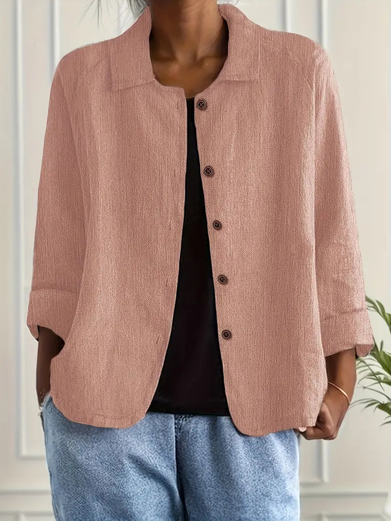 Close-up view of women's button-front shirt showing textured fabric and five-button closure detail