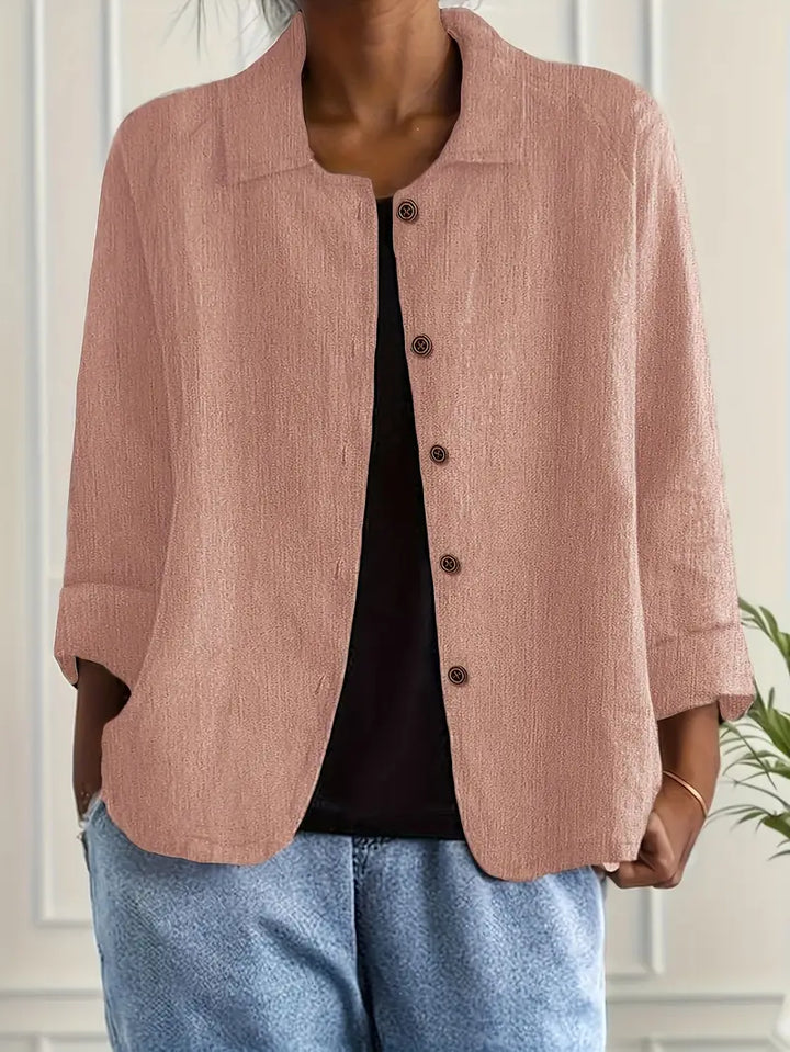 Close-up view of women's button-front shirt showing textured fabric and five-button closure detail