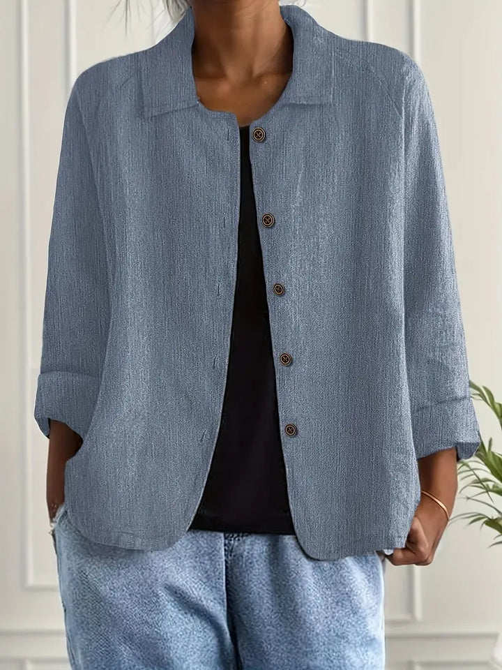 Women's button-front shirt in light blue styled with denim trousers for casual look