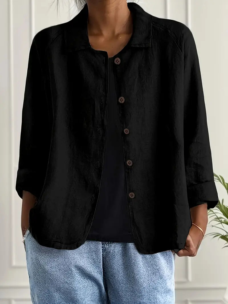 Detail of open collar and button closure on women's three-quarter sleeve shirt