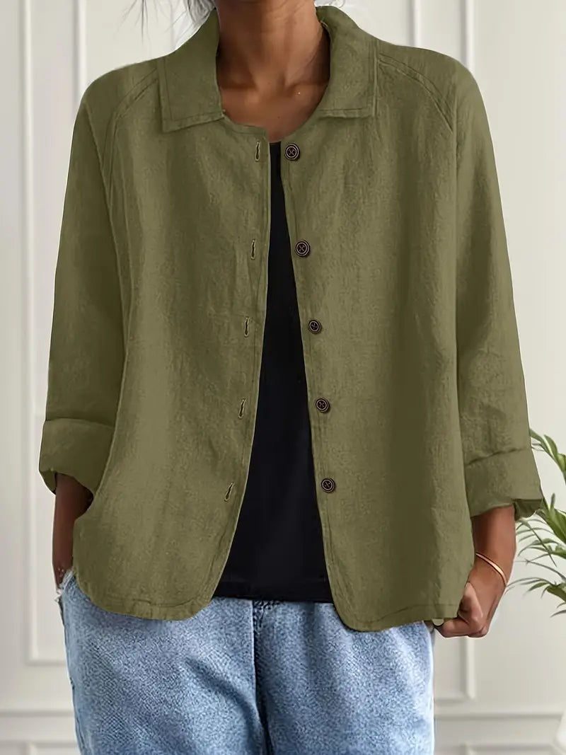 Women's button-front shirt in light blue layered over black vest for effortless style