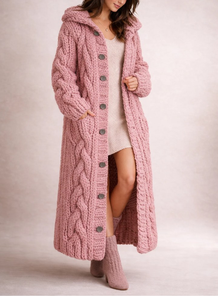 Full-length cable knit hooded cardigan styled over a knit dress with relaxed oversized fit