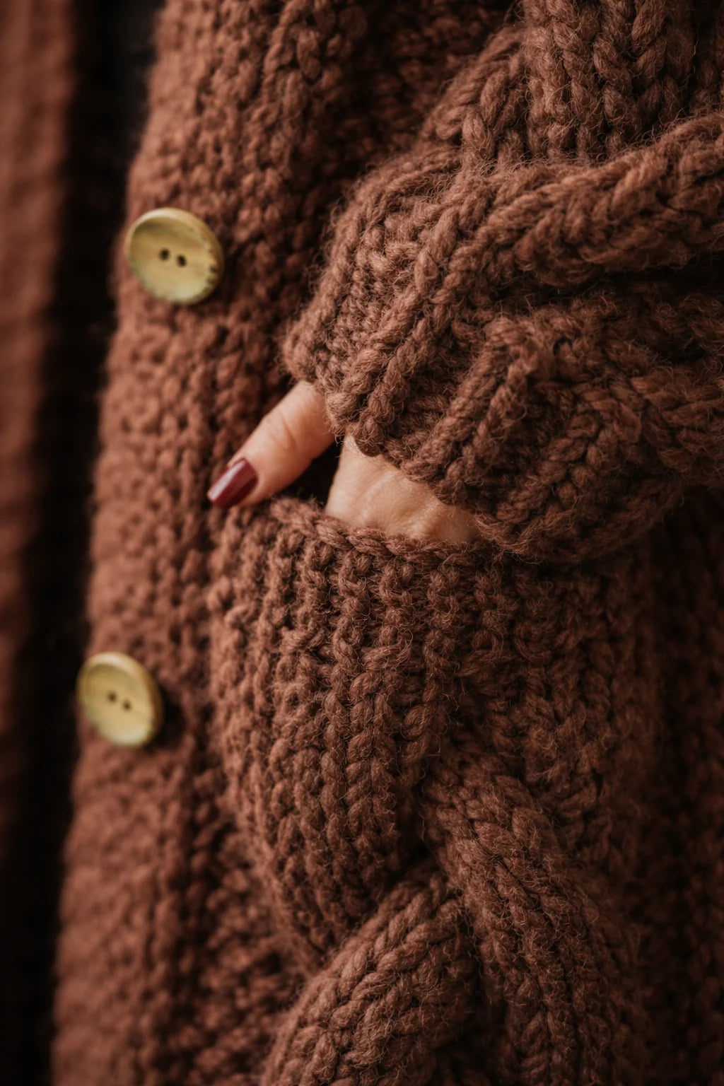 Women's long hooded cardigan in grey with textured cable knit and button-through closure