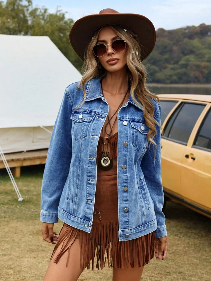 Women's denim jacket with button-front closure and chest pockets styled over a brown top outdoors