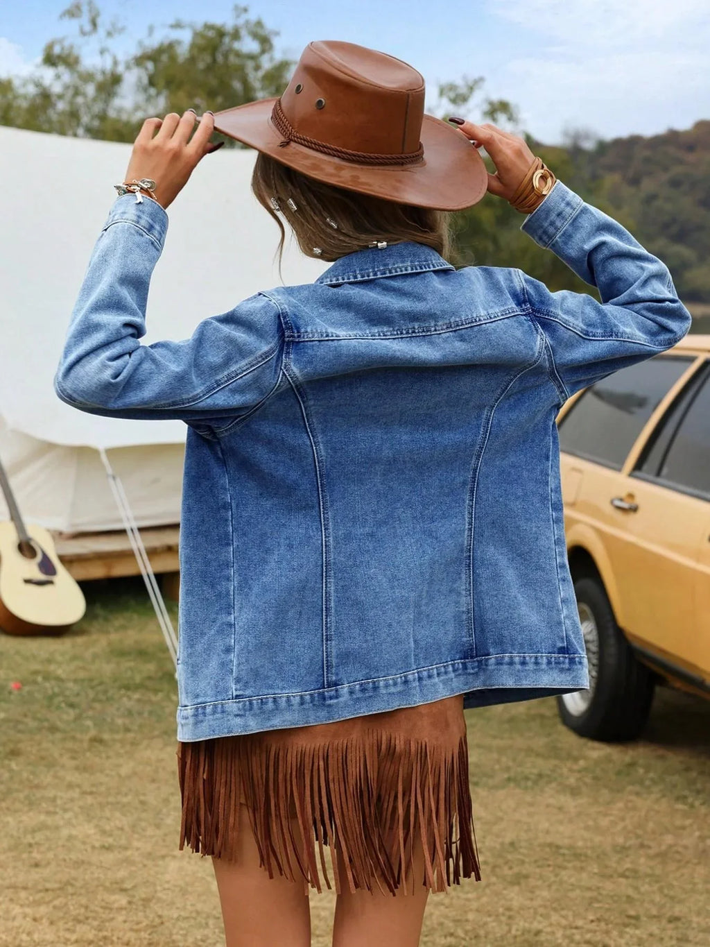 Side view of women's denim jacket displaying relaxed fit and hip-length hem