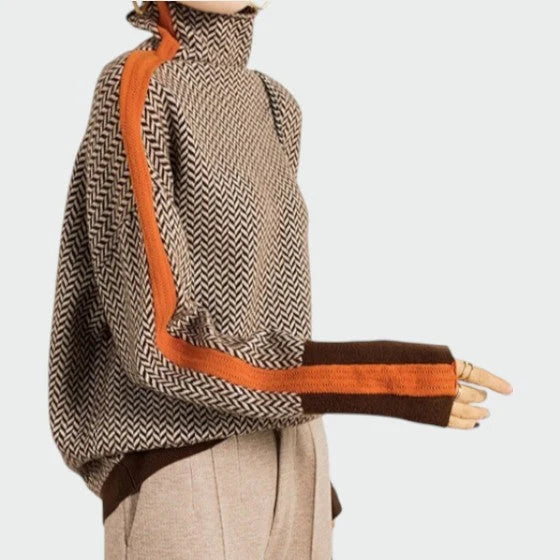 Close-up view of herringbone knit pattern on women's turtleneck jumper showing textured weave detail