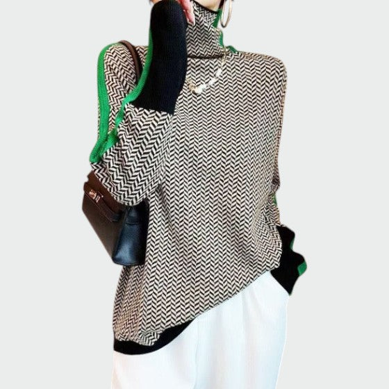 Women's chevron pattern turtleneck jumper styled with trousers showing versatile layering piece