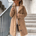Woman wearing a beige oversized teddy coat with notched collar and button-front closure on outdoor steps
