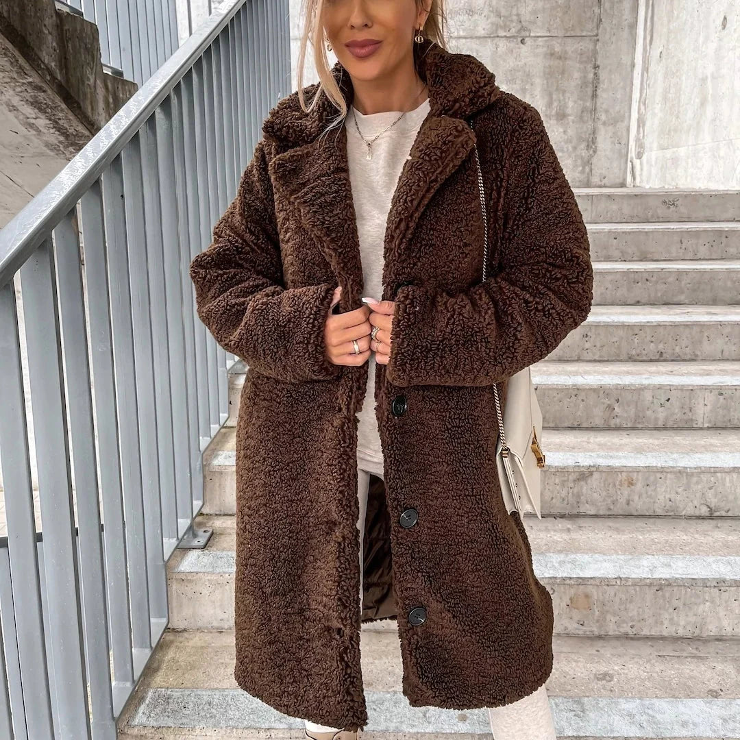 Detail of the button-front closure and notched collar on a women's teddy coat in beige
