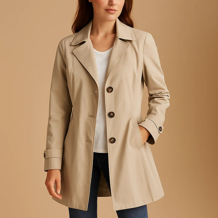Close-up view of structured trench coat with three-button detail and smooth fabric finish