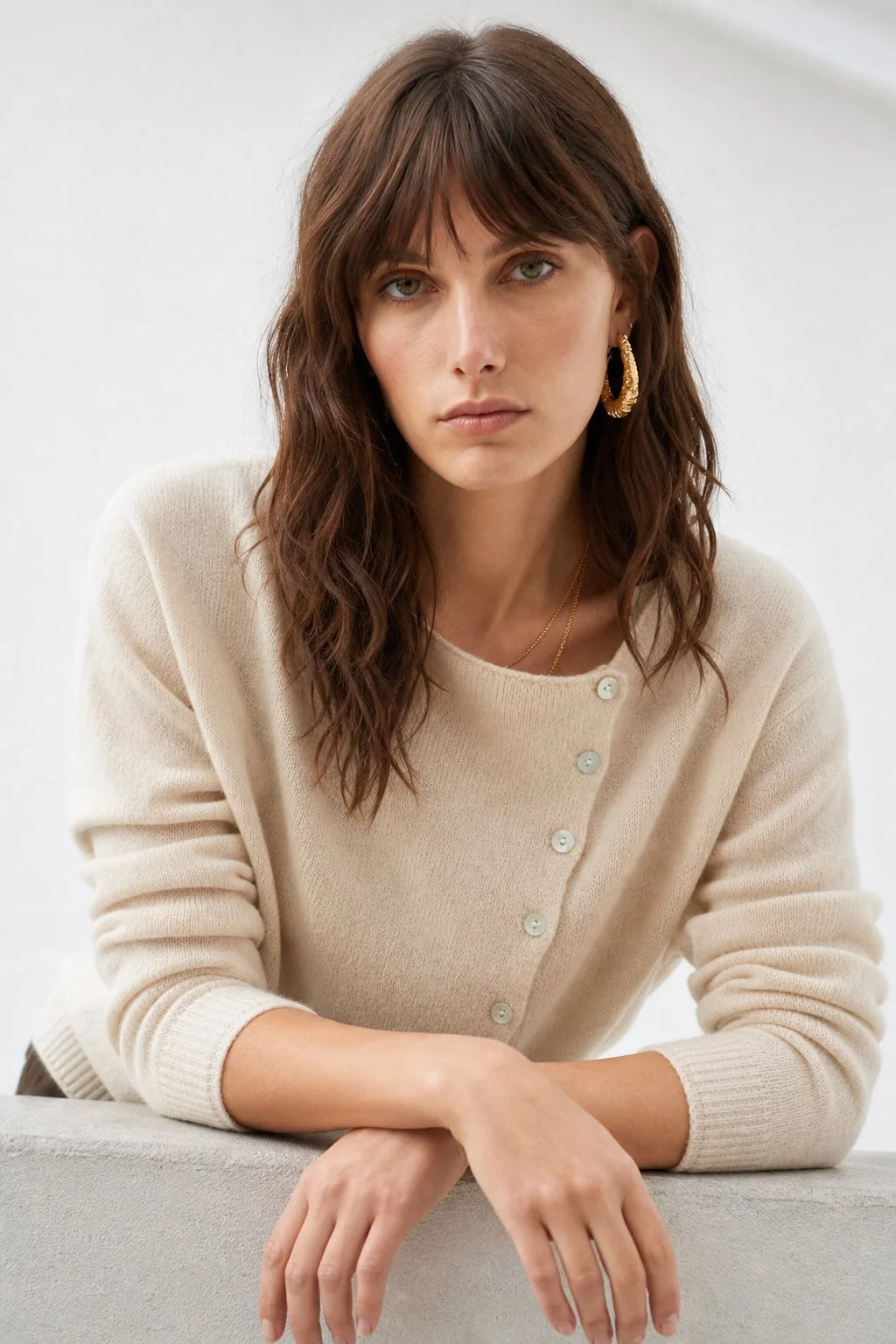 Model in a beige women's cashmere cardigan styled for office-to-evening wear