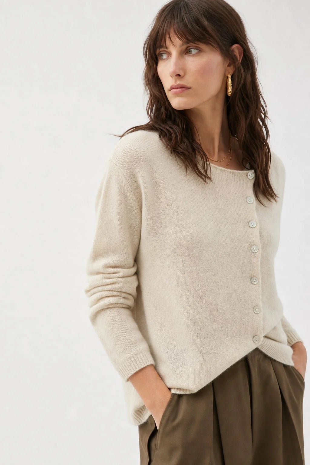 Close-up of the button-front closure on a soft knit cashmere cardigan