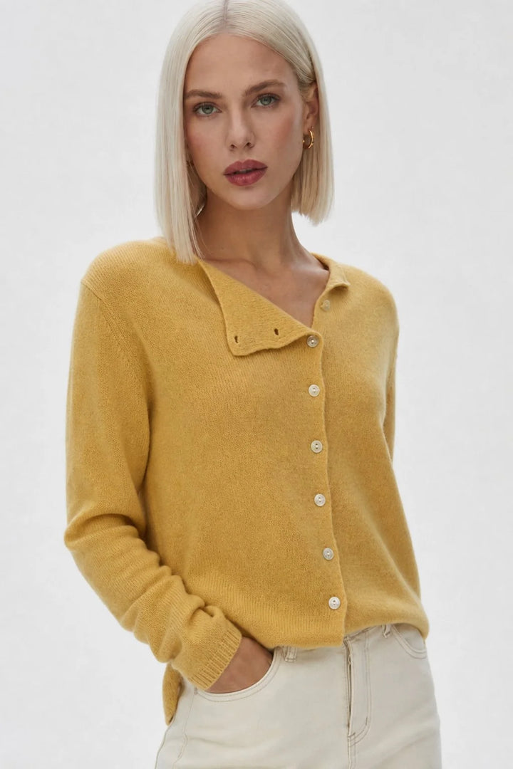 Back view highlighting the even hem and soft knit construction of a beige cardigan