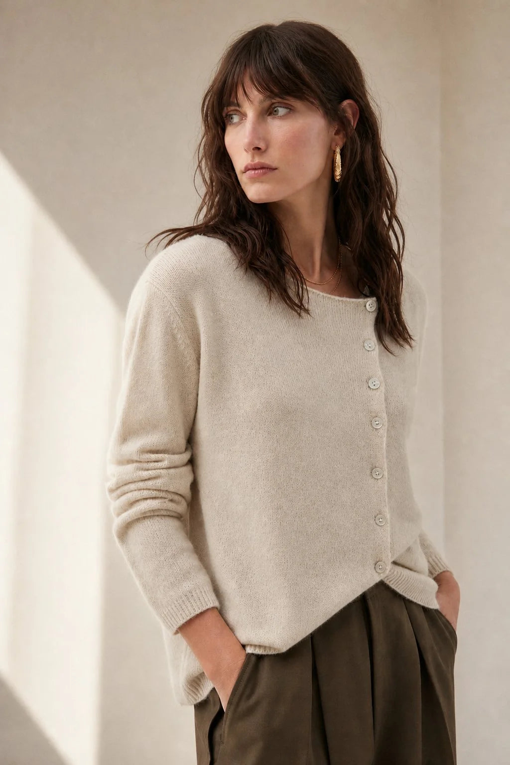 Close-up view of the asymmetric button placket on a soft knit cashmere cardigan for women