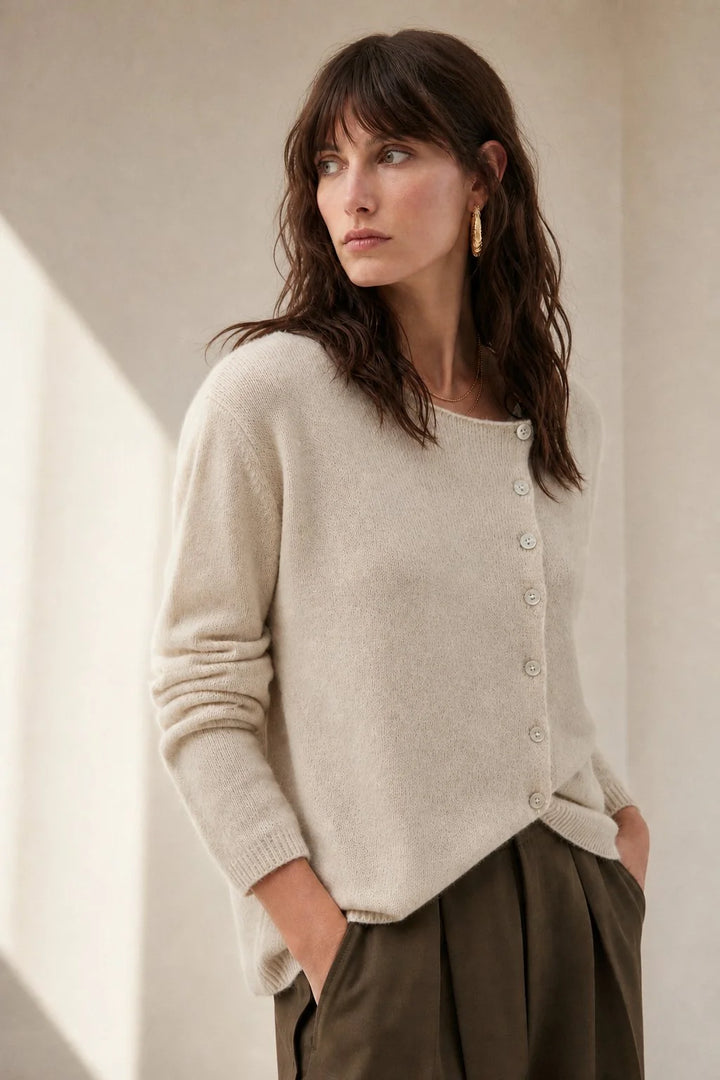 Close-up view of the asymmetric button placket on a soft knit cashmere cardigan for women