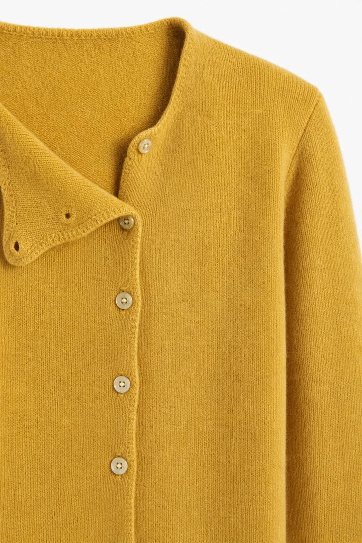 Front view of a beige asymmetric button cardigan with round neckline and relaxed fit