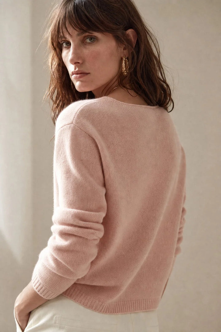 Side profile showing the relaxed drape and long sleeves of a women's cashmere button cardigan