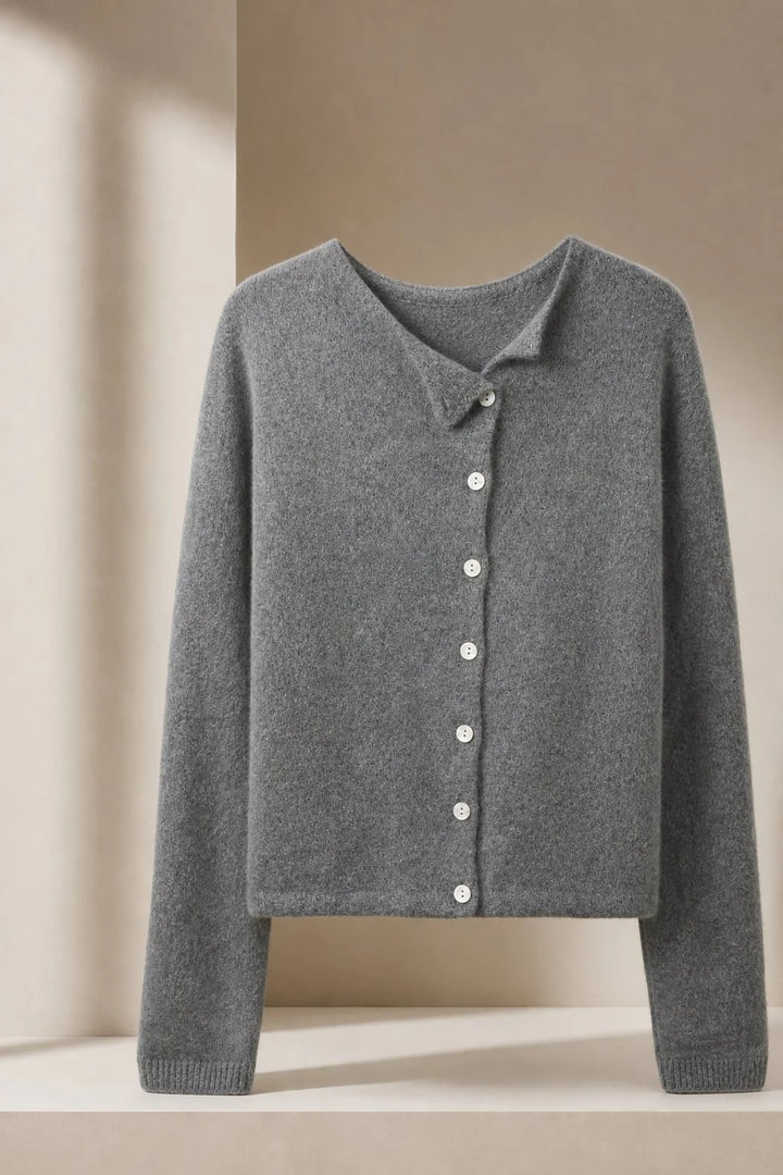 Three-quarter view highlighting the asymmetric button detail on a relaxed-fit cardigan
