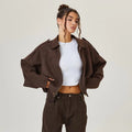 Close-up detail of women's cropped zip jacket showing point collar and concealed zip fastening