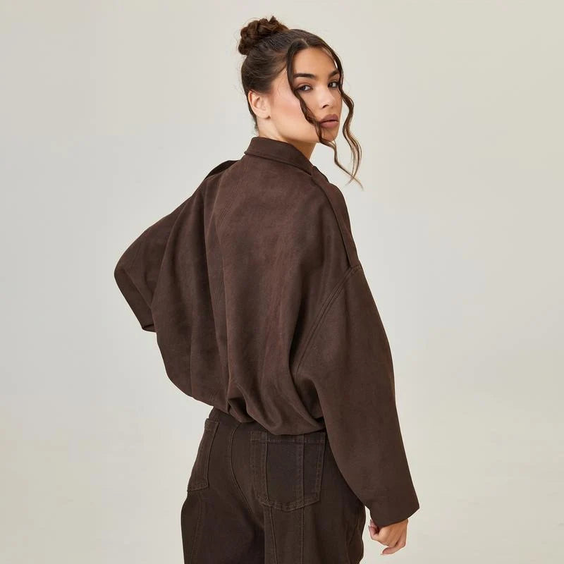 Side view of women's cropped zip jacket displaying relaxed fit and dropped shoulder seams