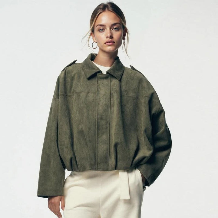 Women's cropped zip jacket styled with trousers showing cropped waist-length fit