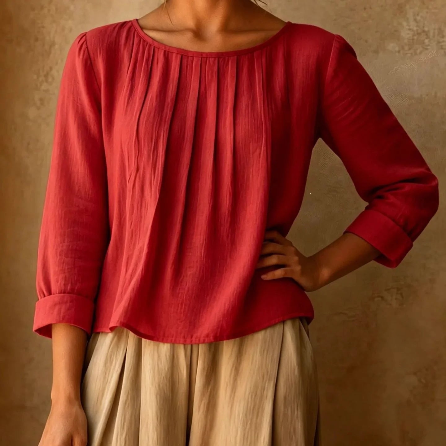 Side view of women's pleated blouse with relaxed fit and lightweight woven fabric falling at the hip