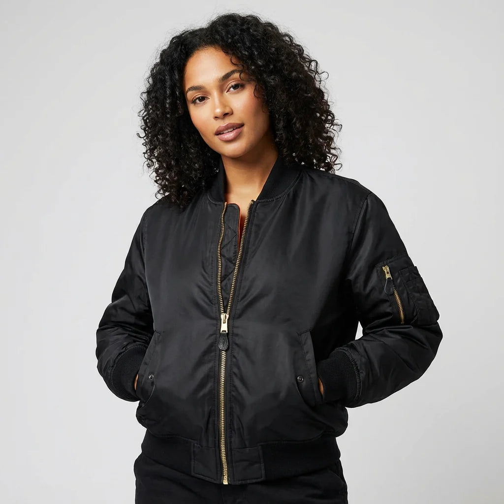 Side angle of women's red bomber jacket with relaxed fit and ribbed cuffs