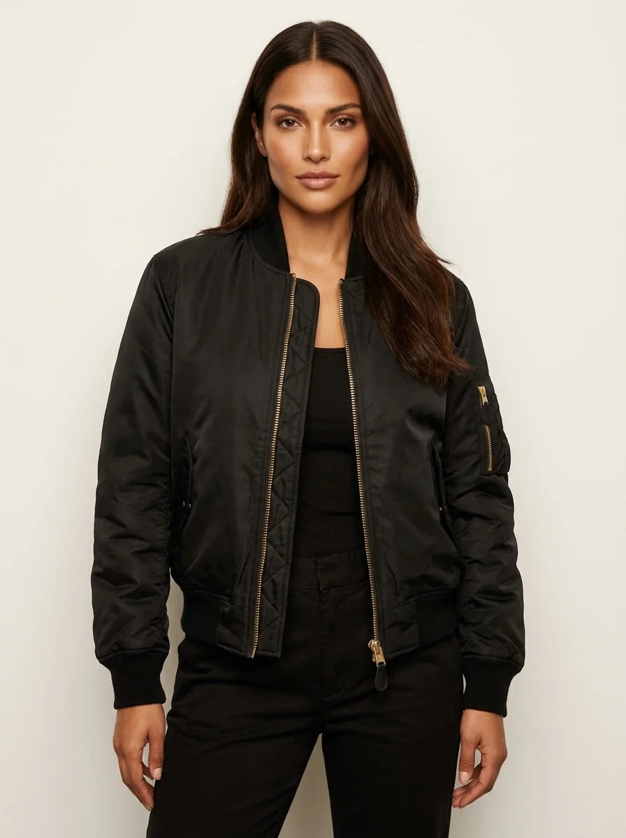 Women's satin bomber jacket styled with white tee and black trousers for casual look