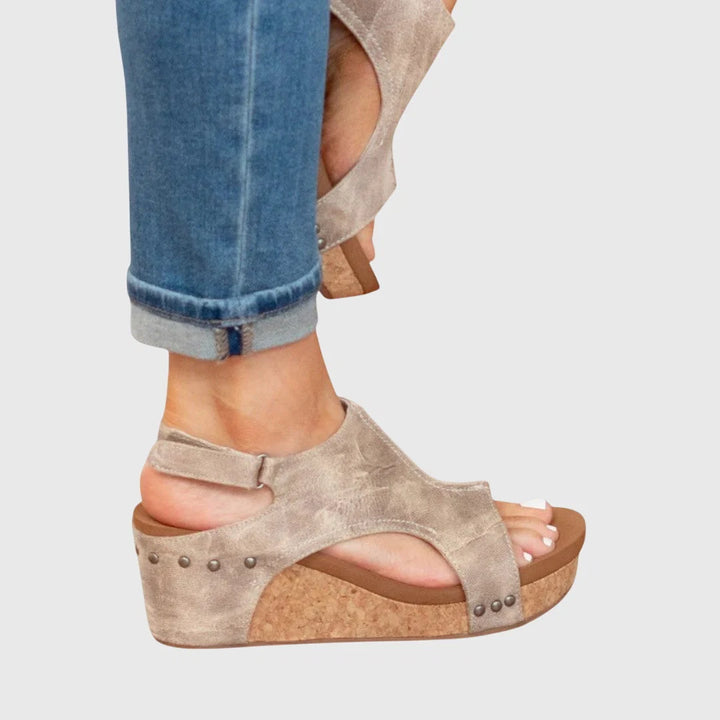 Women's platform wedge sandals styled with rolled-cuff jeans for casual everyday wear