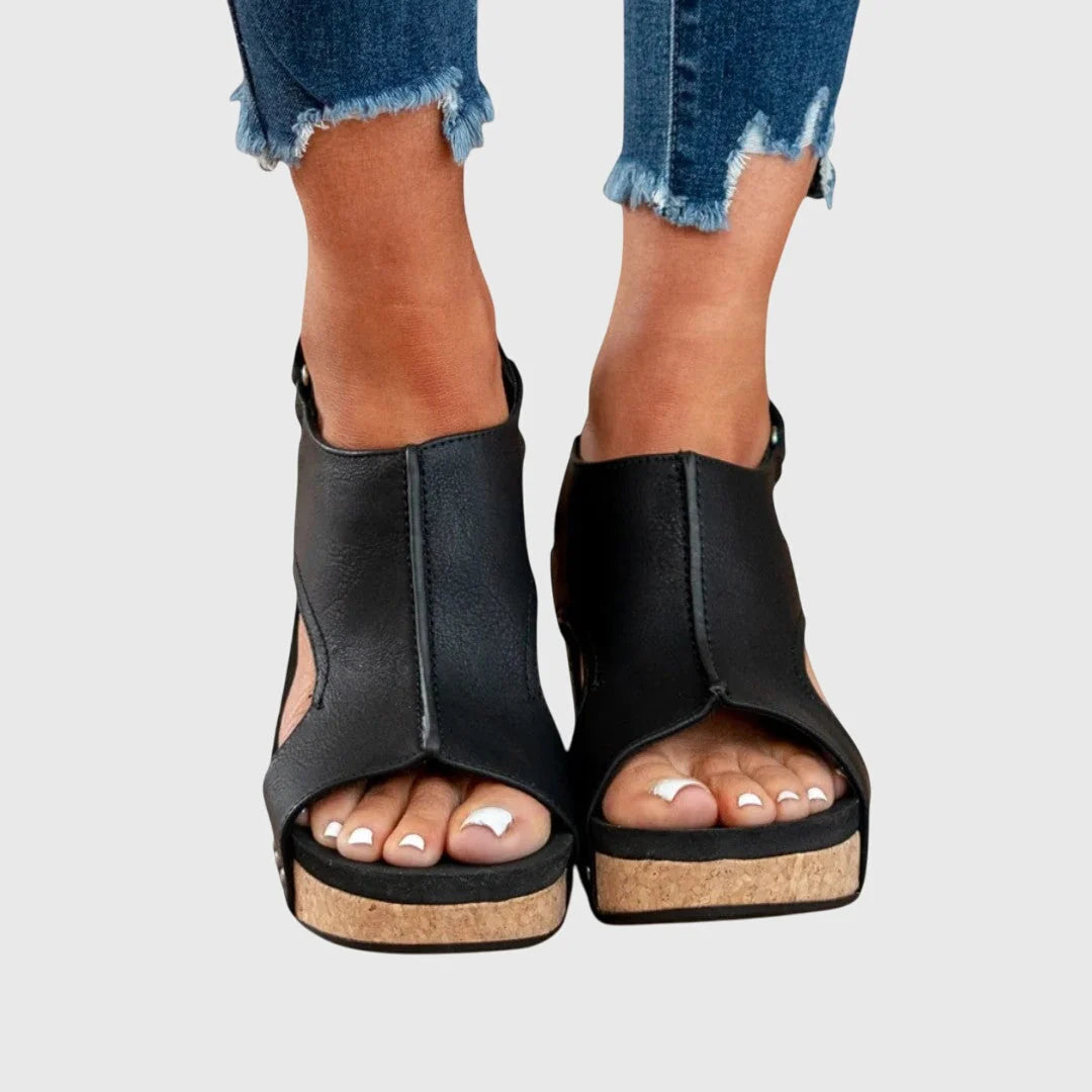 Detail of beige wedge sandals featuring soft-textured upper and cork-effect sole