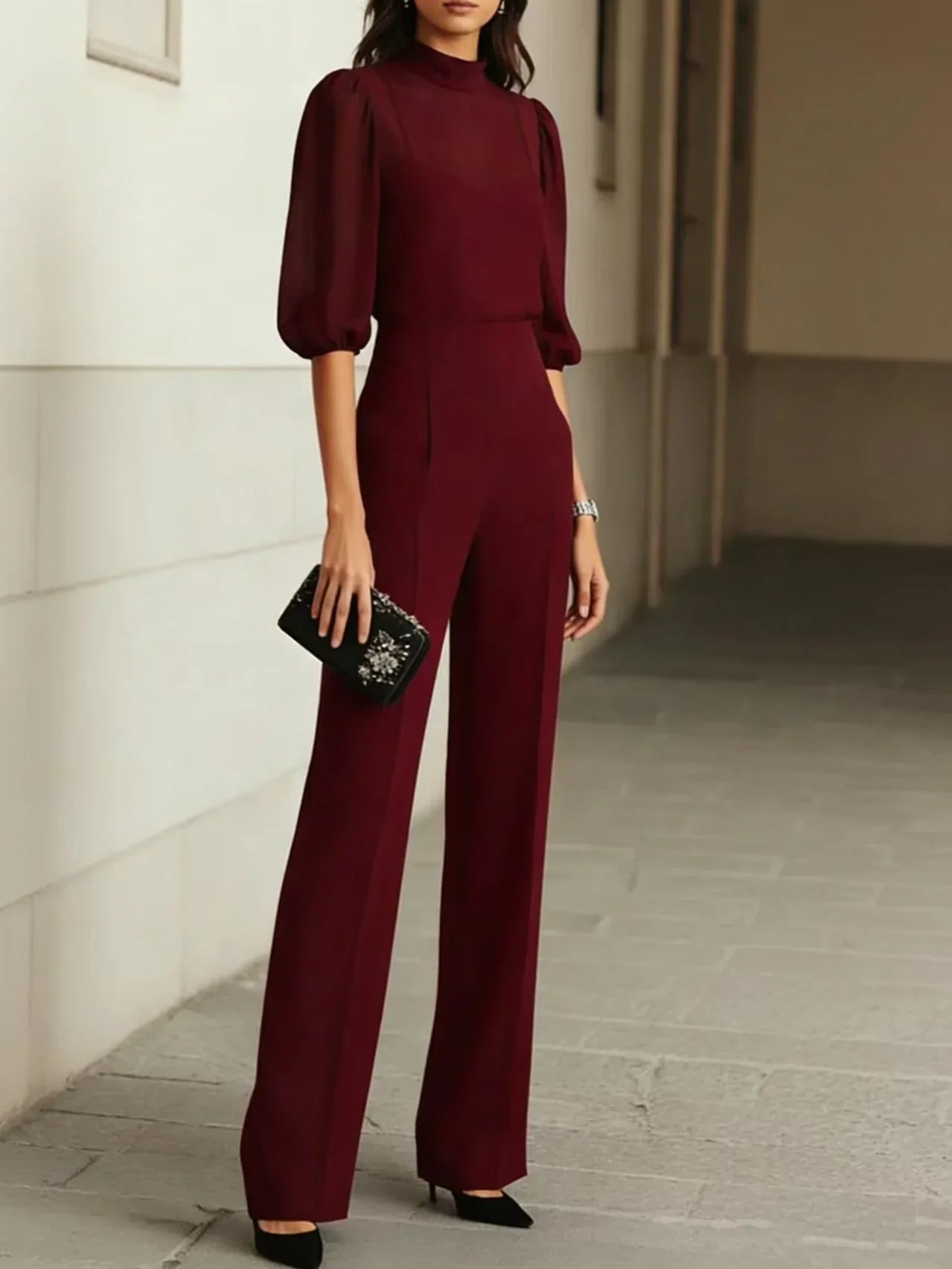 Side view of wide leg trousers with front pleats and high waist fit in black