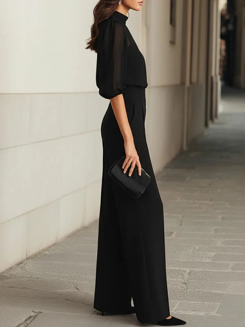 Back view of wide leg trousers and sheer blouse set showing relaxed drape and tailored fit