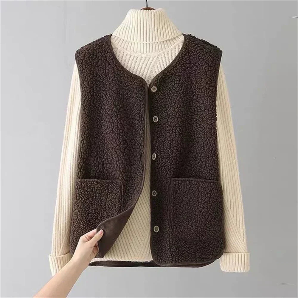 Women's fleece gilet in brown with button-up front and side pockets, layered over cream turtleneck jumper