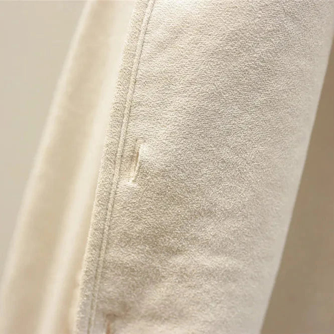 Detail of fleece gilet pocket and textured outer fabric on brown sleeveless waistcoat