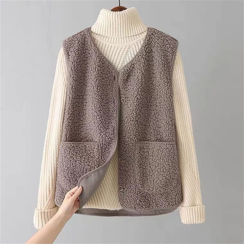 Brown fleece gilet styled with cream turtleneck, showing sleeveless design and textured fleece outer fabric