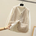 Brown fleece waistcoat layered over cream ribbed jumper, displaying button-up front and side pockets