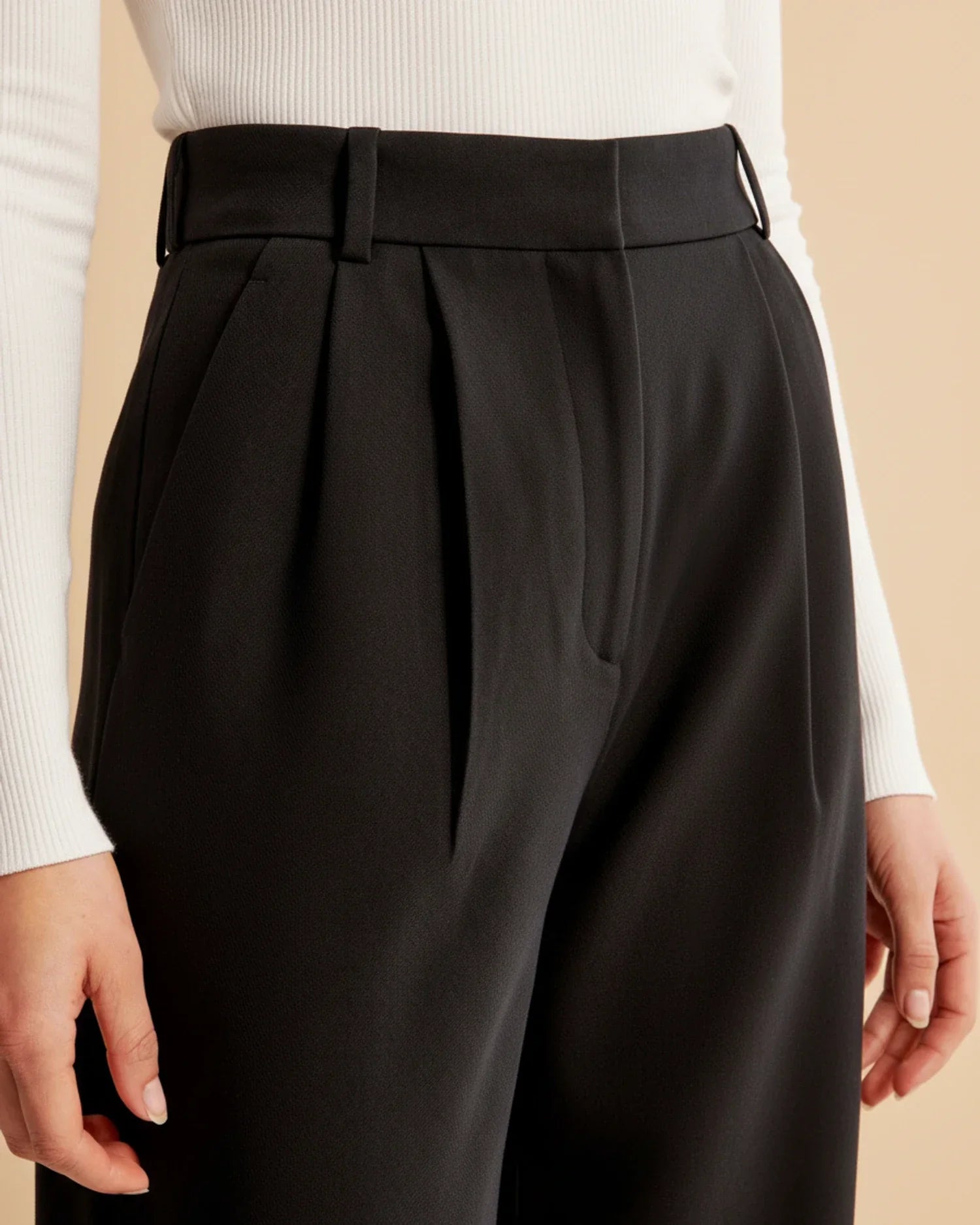 Full outfit featuring high waist pleated trousers with black jumper and minimal accessories