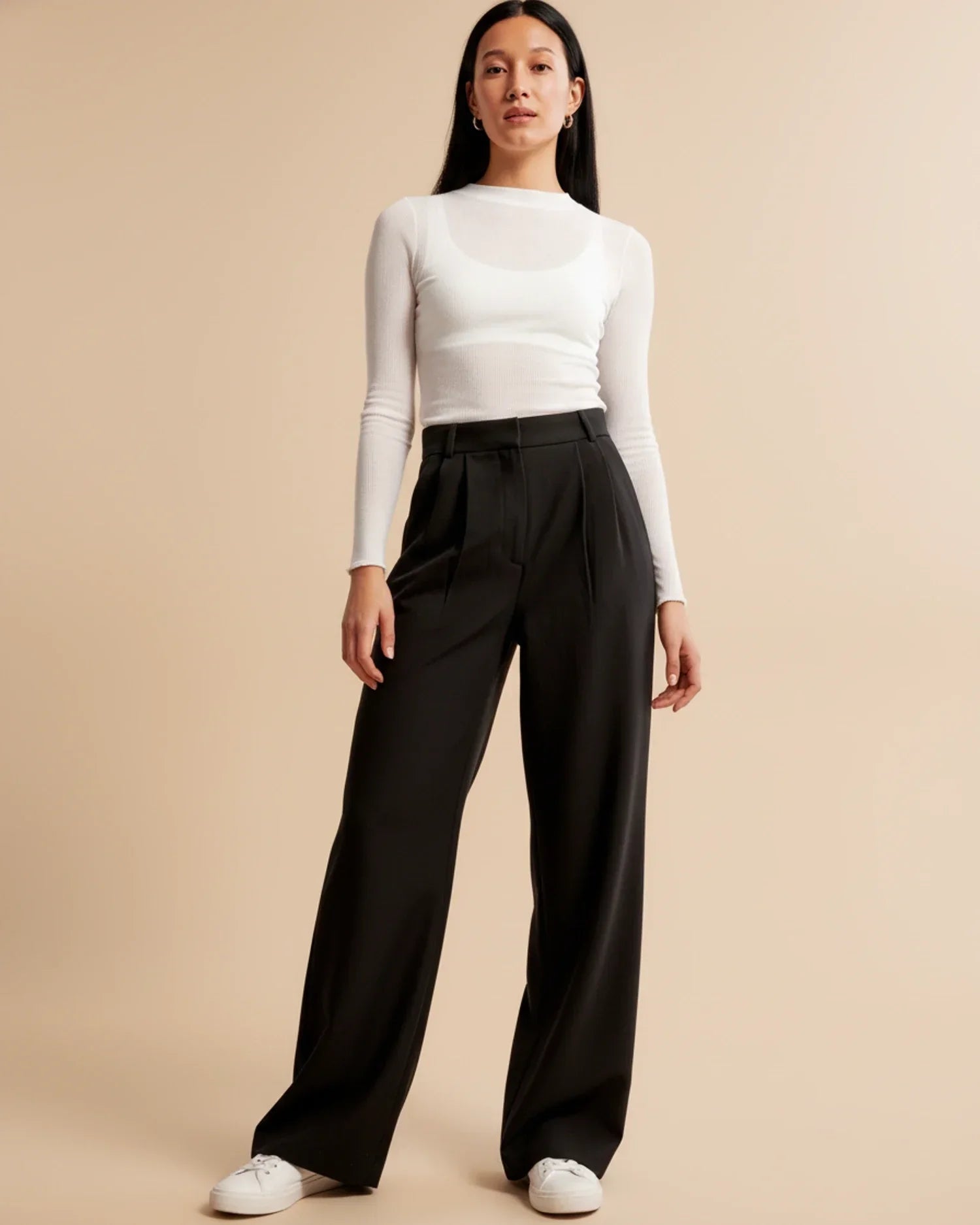 Women's high waist pleated trousers in beige styled for office or casual wear