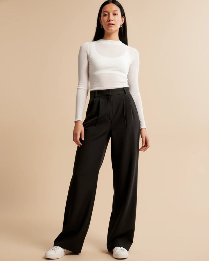 Women's high waist pleated trousers in beige styled for office or casual wear
