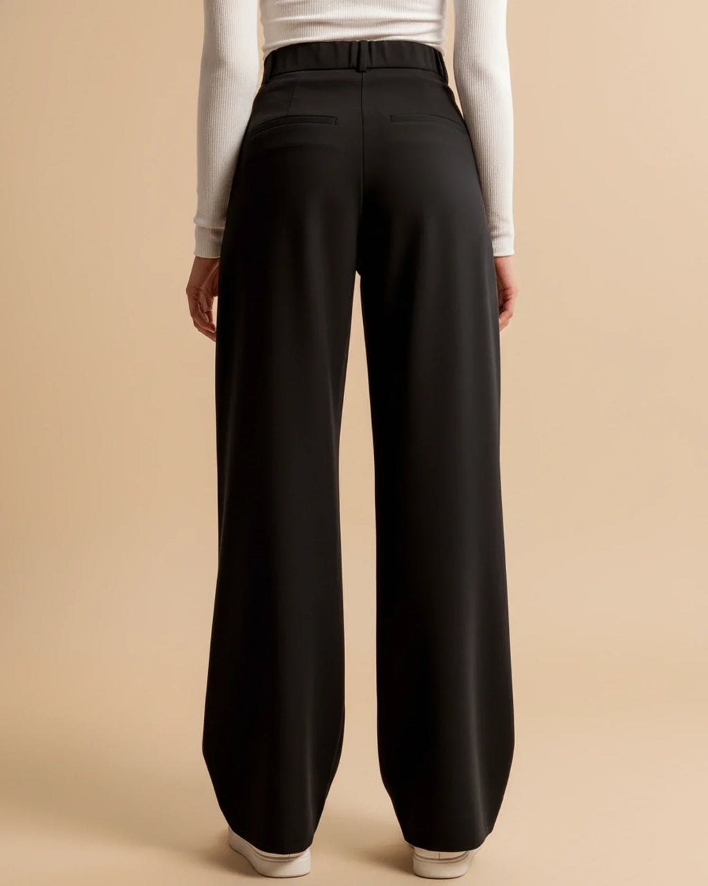 Women's pleated trousers in beige showing versatile styling for work or weekend